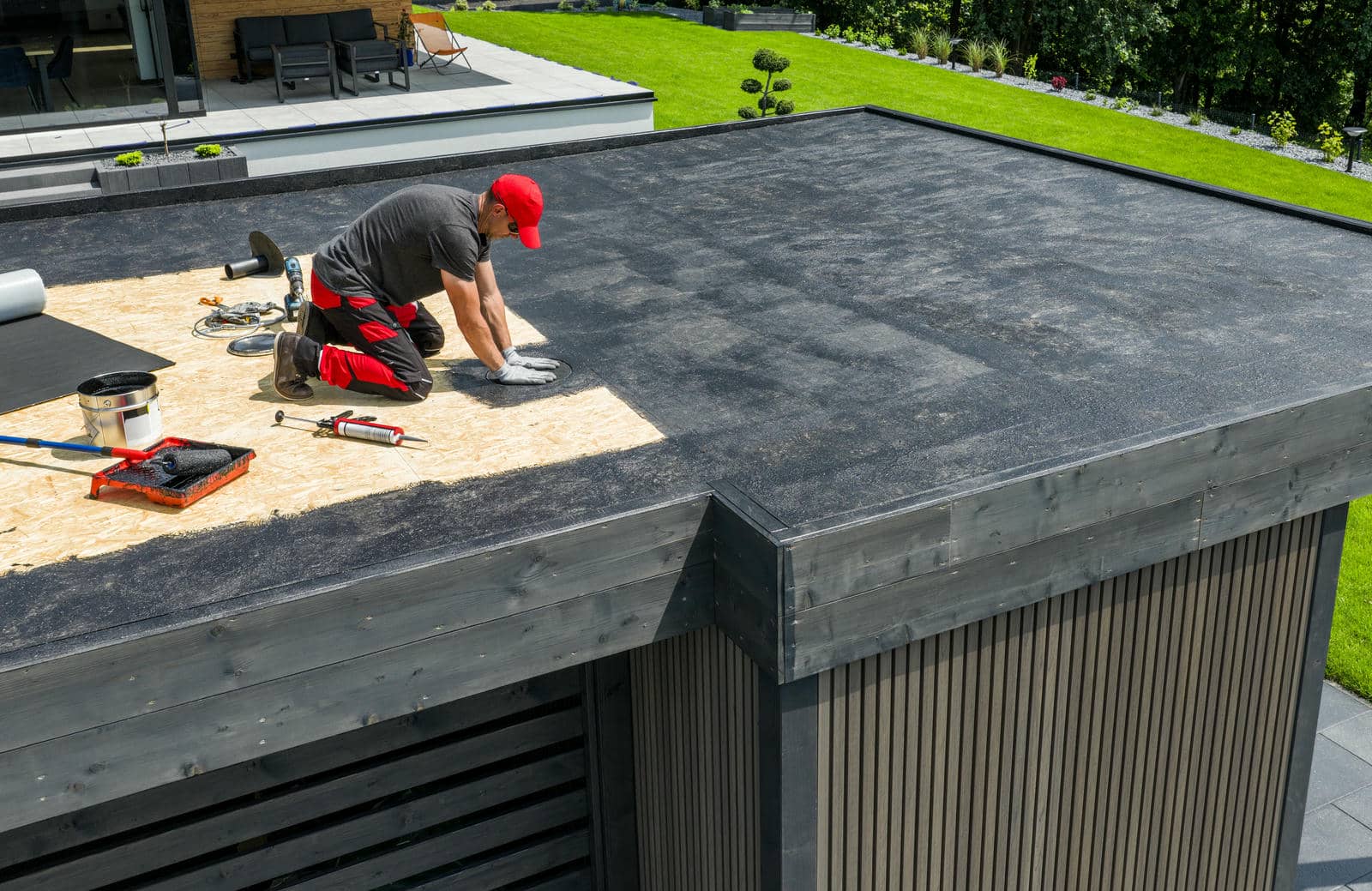 Worker repairing a flat roof.