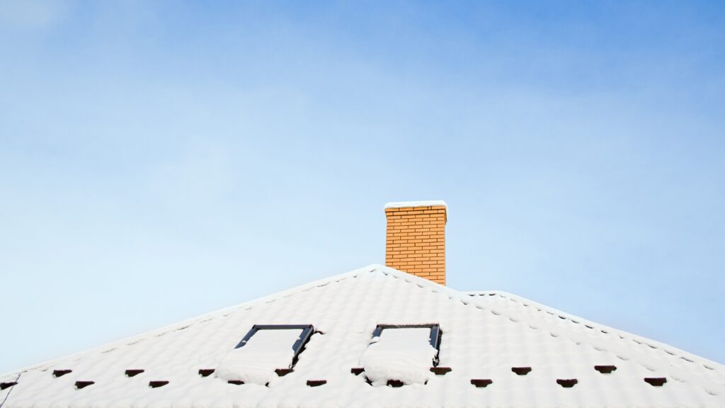 Do you need new roofing? Picture of a snowtop covered roof.