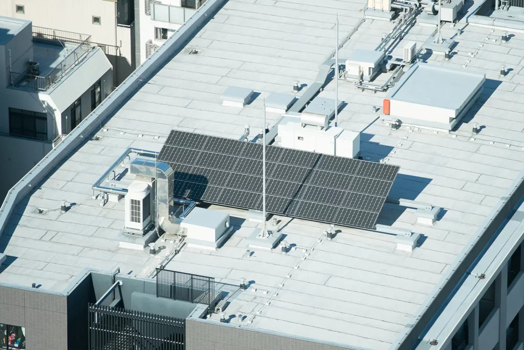 A business rooftop with solar panels, showcasing some eco-smart commercial top covers