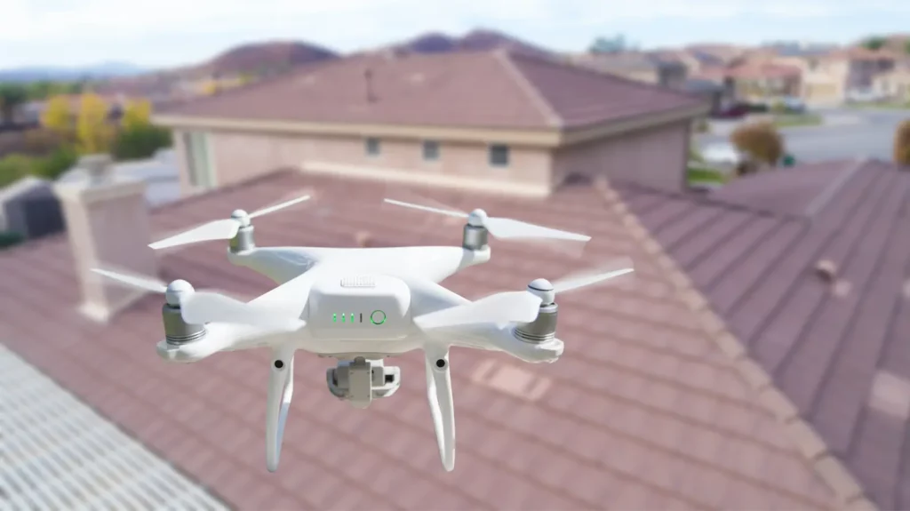 A drone flying over a roof, one of the best commercial roof automation breakthroughs