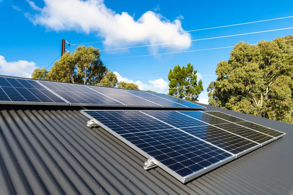 Black metal roof with solar panels one of the top 10 Sustainable Commercial Roofing Materials