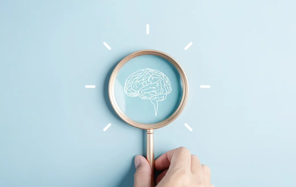 Magnifying glass on top of a brain drawing, depicting AI, one of the top 15 Advances in Commercial Roofing Automation