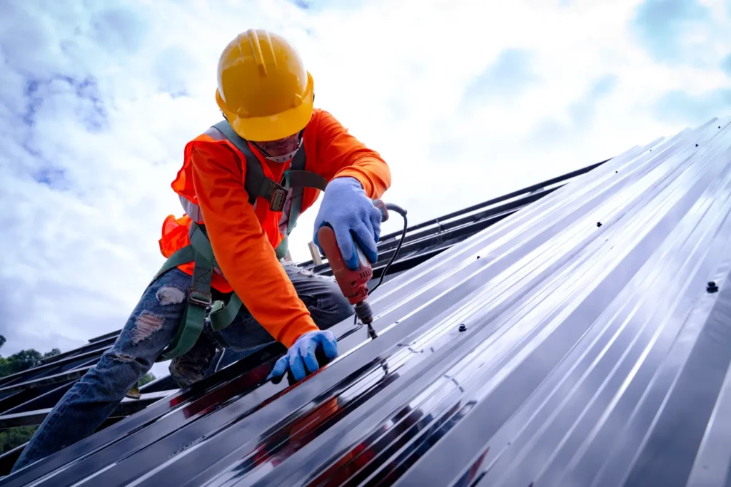 Sustainable Commercial Roofing. Roofer working on roof structure of building on construction site