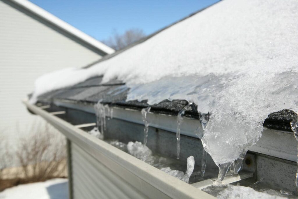 Snow melting on roof gutter
