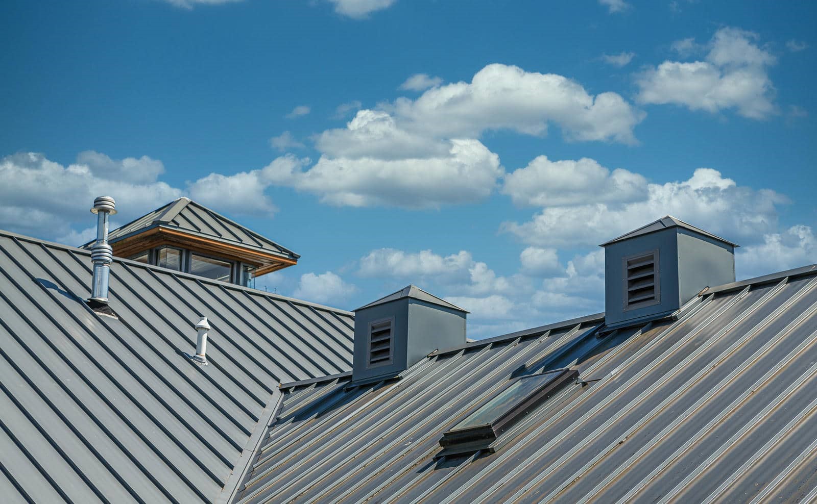 Metal roofs under a blue sky