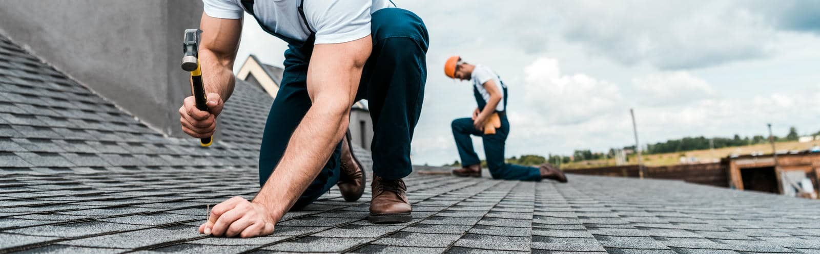 Workers repairing a roof in autumn.