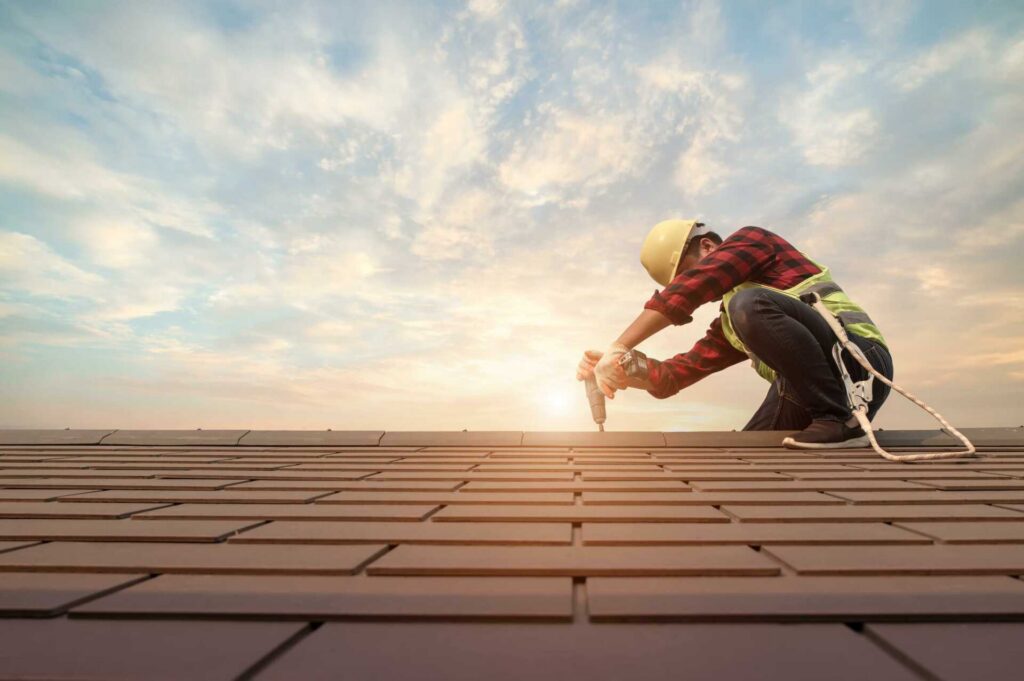 11 Top Energy-Efficient Roofing Solutions for Businesses|Roofing Solutions for Businesses. Roofer worker using air or pneumatic nail gun