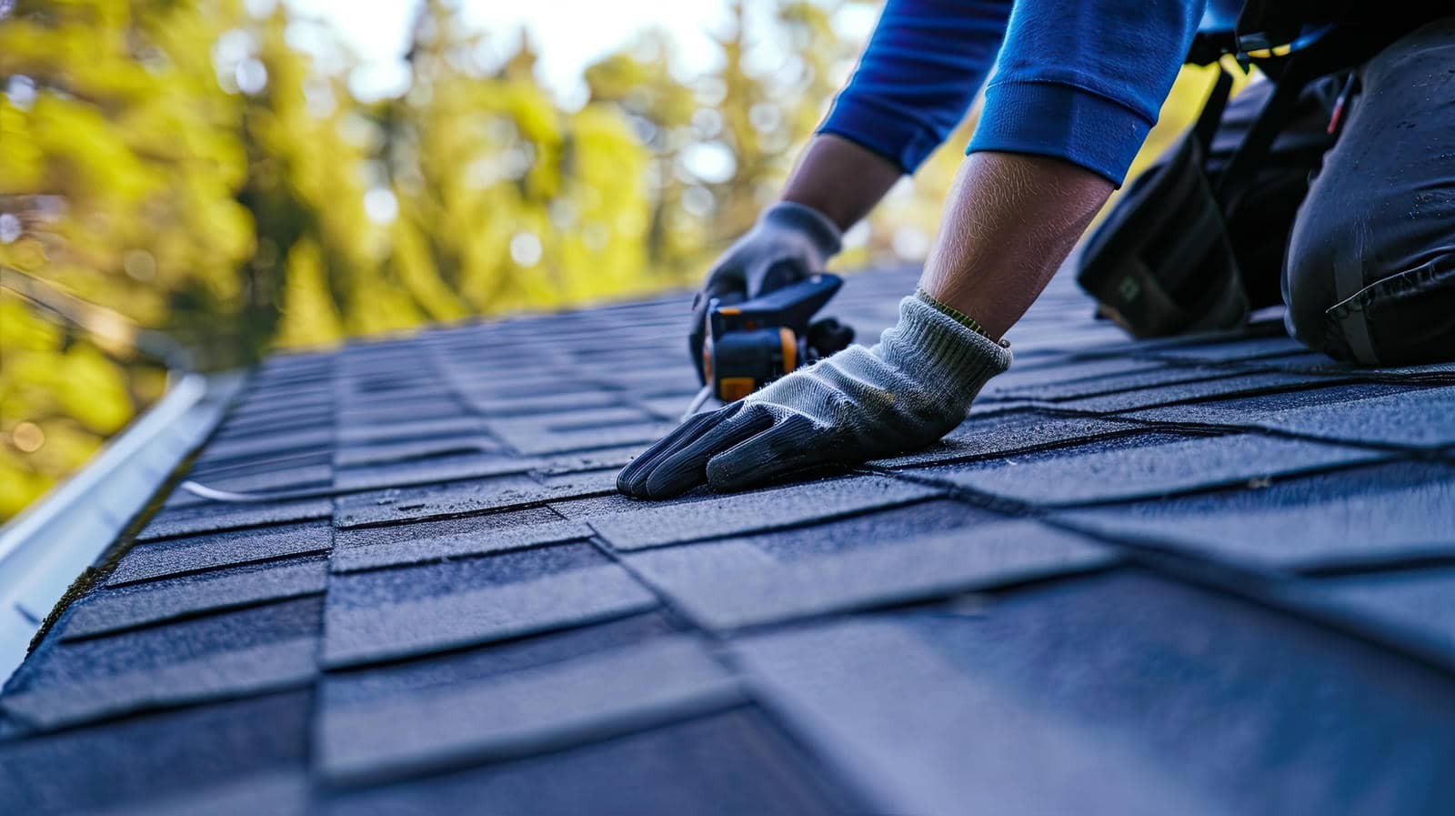 Person installing shingles on a roof