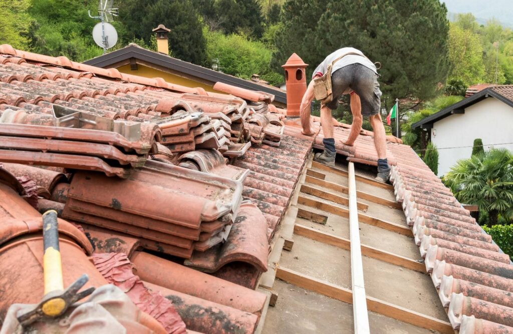 Worker repairing a tiled roof